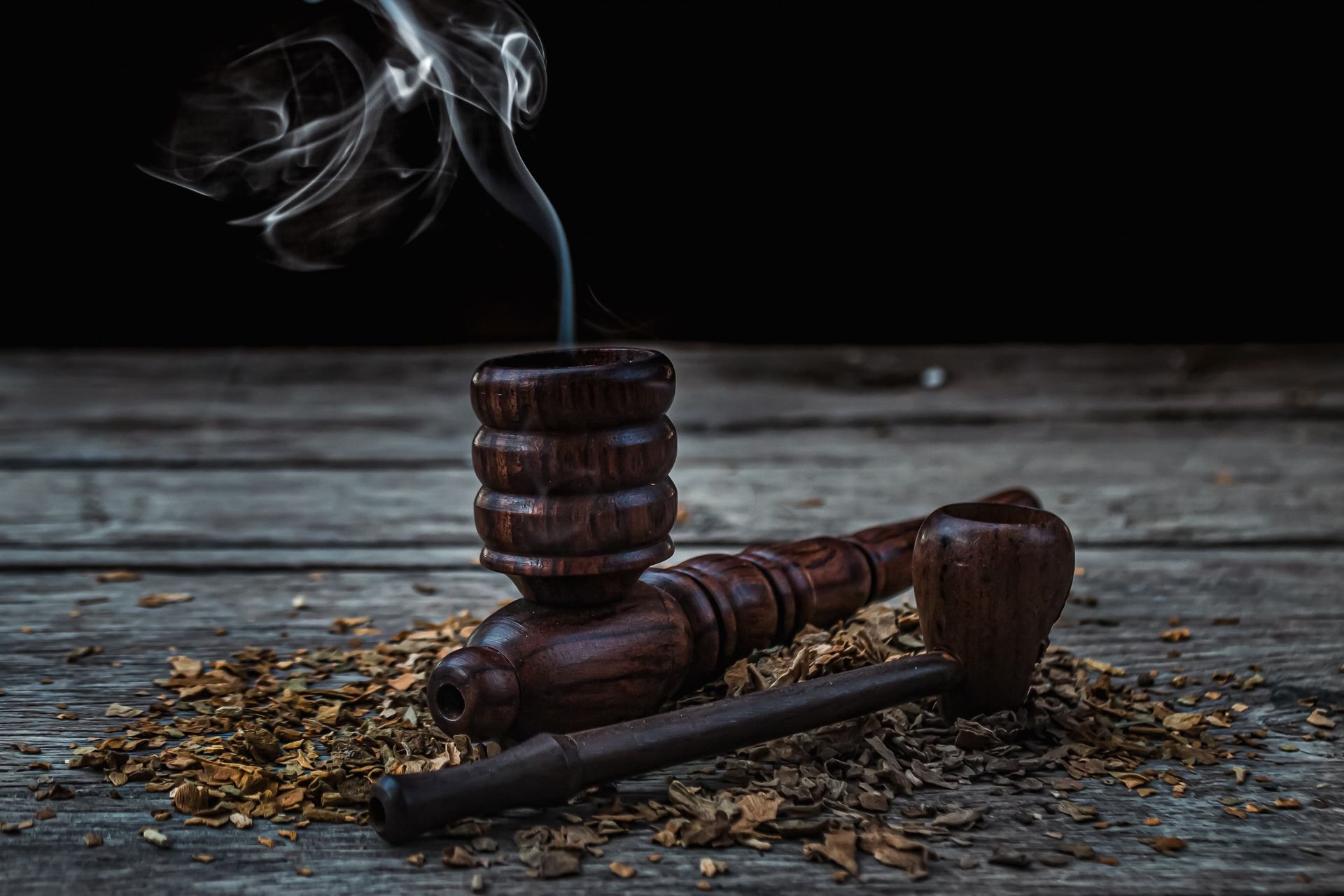 Traditional wooden smoking pipes with aromatic smoke in Varanasi, India setting.